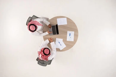 Saudi Businessmen Working with Laptop Overhead View