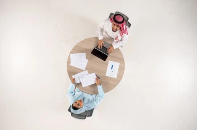 Saudi Businessman and Woman in Office Meeting Top View