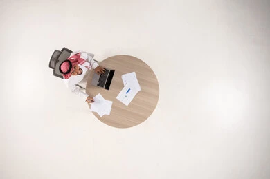Saudi Businessman Working at Desk Top View