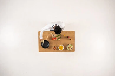 Arab Man Cooking on Wooden Table Overhead View