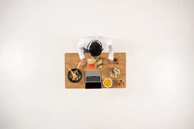 Arab Man Cooking with Laptop Top View