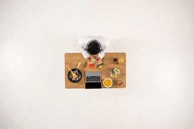 Arab Man Cooking at Desk with Laptop Top View