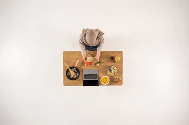 Saudi Woman Cooking with Laptop Top View Studio Shot
