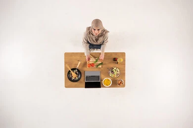 Arab Woman in Hijab Cooking with Laptop Top View
