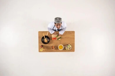 Omani Man Preparing Food Overhead View White Background