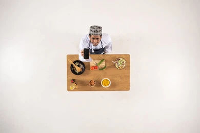 Omani Man Chef Cooking with Smartphone Top Down View