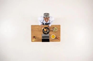 Omani Man Cooking with Laptop Studio Overhead View