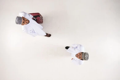 Omani Men with Suitcase Top-Down View