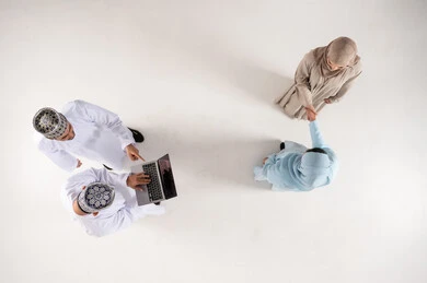 Omani Business Professionals Networking with Laptop Top View