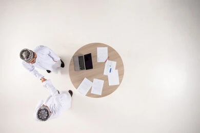 Omani Businessmen Handshake Top View Office Setting