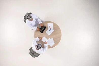 Omani Businessmen Working at Round Table Top View