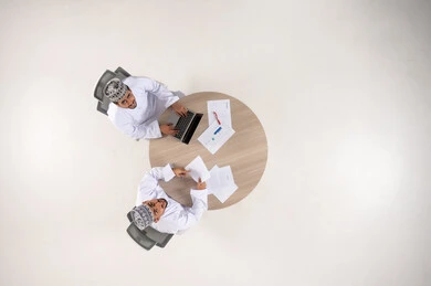Omani Businessmen Working at Table Top View