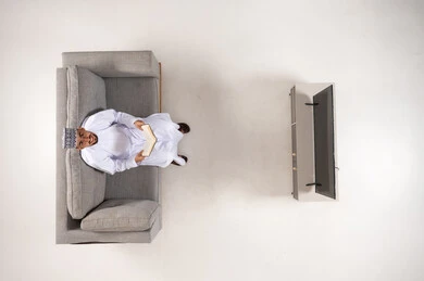 Omani Man Reading Book on Sofa Top View