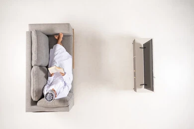 Omani Man Reading Book on Sofa Top View