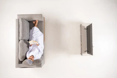 Omani Man Reading Book on Sofa Top View