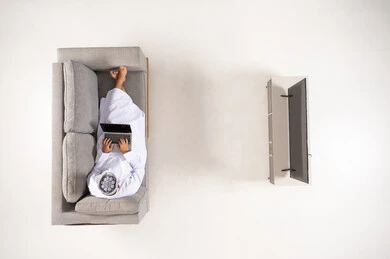 Omani Man with Laptop on Sofa Top View Minimalist Room