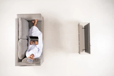 Omani Man on Sofa Using Laptop Top View
