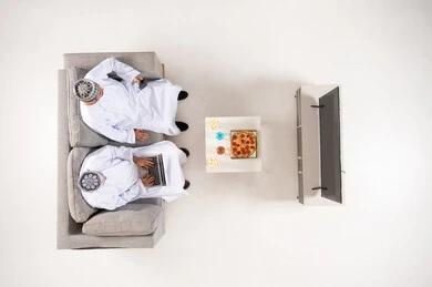 Omani Men with Laptop and Smartphone Top View
