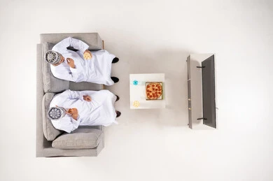 Omani Men in Traditional Dress Watching Television Top View