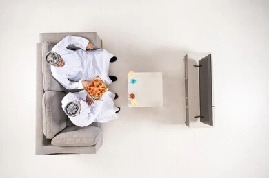 Omani Men Eating Pizza Overhead View