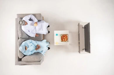 Omani Couple Watching TV from Overhead View