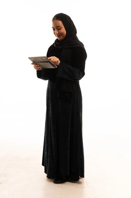 Saudi Woman in Black Abaya Using Digital Tablet