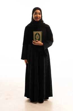 Saudi Woman in Black Abaya Holding Holy Quran