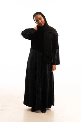 Arab Woman in Black Abaya Touching Neck in Studio