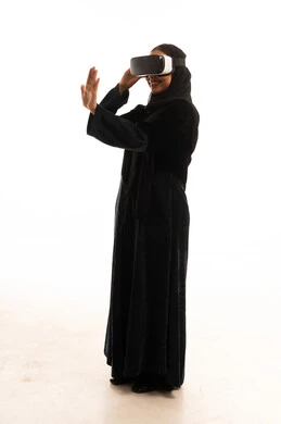 Saudi Woman in Abaya Using VR Headset on White Background