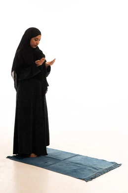 Muslim Woman in Black Abaya Praying on Blue Mat