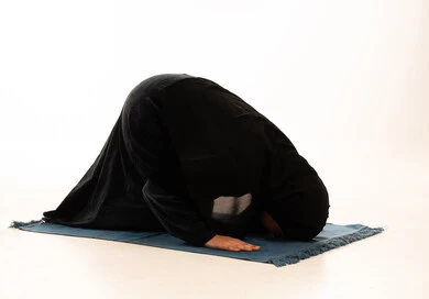 Saudi Woman in Niqab Praying Sujud on White Background