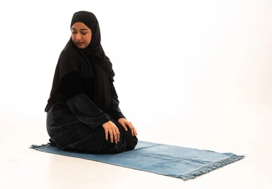 Saudi Woman Praying on Blue Rug White Background