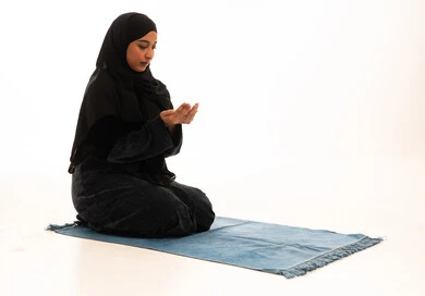 Saudi Woman in Black Abaya Praying on Mat