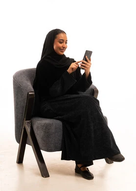 Saudi Woman in Black Abaya Using Smartphone