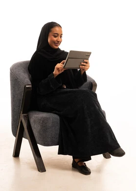 Saudi Woman in Abaya Using Digital Tablet