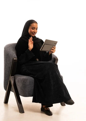 Saudi Woman in Abaya Using Tablet on White Background