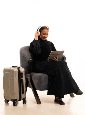 Saudi Woman with Suitcase and Tablet in Studio