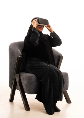 Saudi Woman in Abaya Using VR Headset in Studio