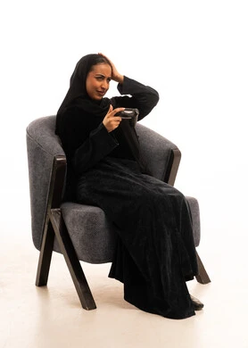 Saudi Woman in Abaya Playing Video Games Frustrated