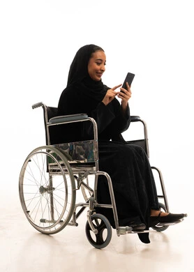 Saudi Woman in Wheelchair Using Smartphone Saudi Woman in Wheelchair Using Smartphone