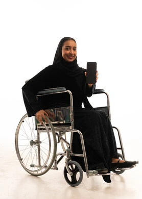 Saudi Woman in Wheelchair Holding Smartphone in Studio