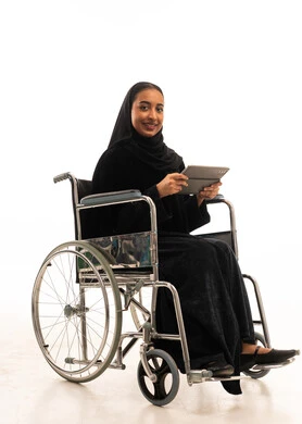 Saudi Woman in Wheelchair with Tablet on White Background