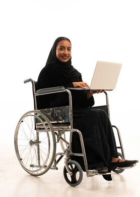 Saudi Woman in Wheelchair Using Laptop on White Background