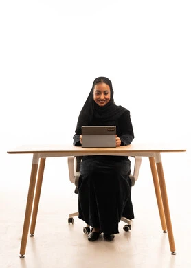 Saudi Woman Using Tablet at Office Desk