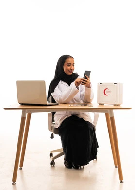 Saudi Female Doctor using Smartphone in Office