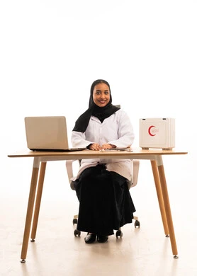 Saudi Female Doctor at Desk with First Aid Kit