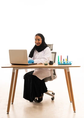 Saudi Female Scientist Working on Laptop in Laboratory