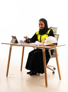 Saudi Female Engineer in Abaya Working on Blueprints