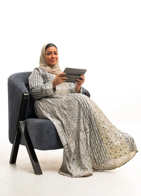 Saudi Woman in Traditional Jalabiya Using Tablet