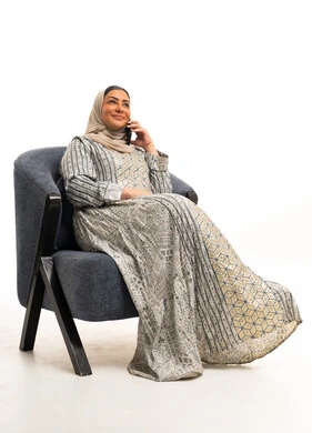 Arab Woman in Traditional Jalabiya Using Smartphone